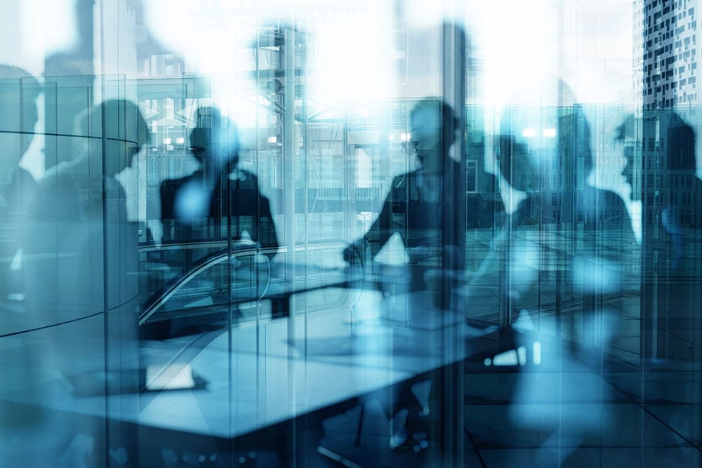 Business professionals collaborating in a modern office, representing managed IT support for growing businesses in Leeds.